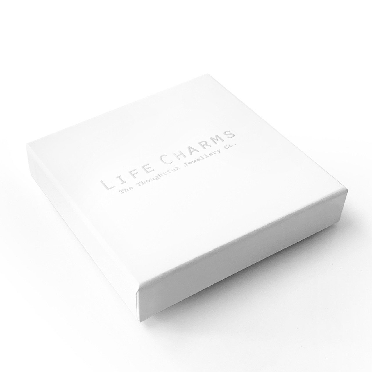 White cardboard box with a rainbow-themed design, likely a gift box