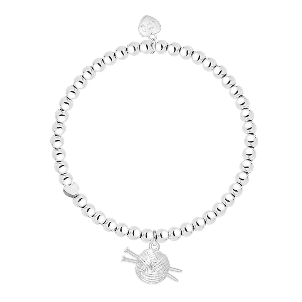 Silver knit love bracelet with a small wooden ball needle, showcasing a delicate knit design
