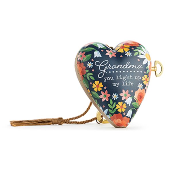 Heart-shaped musical keepsake with navy blue background, colourful floral design, and the words “Grandma, you light up my life.” Includes gold key and tassel.