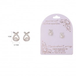 Close-up of four white pearl stud earrings set in a silver setting, with EQ branding