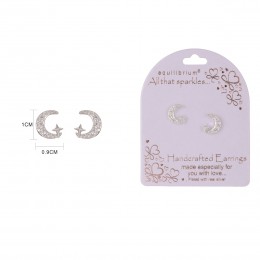 Close-up of a set of silver stud earrings featuring a moon and star design