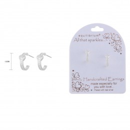 Silver hoop earrings featuring a heart-shaped charm, set in a polished silver setting