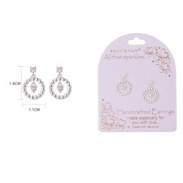White crystal drop earrings with a circular halo setting, featuring the Equilibrium brand