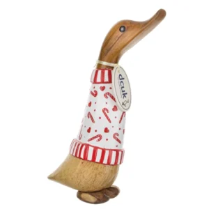 Hand-carved DCUK candy cane duckling wearing a red and white Christmas jumper, standing on a wooden surface.